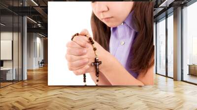 girl child praying holding wooden rosary in hands on close up Wall mural