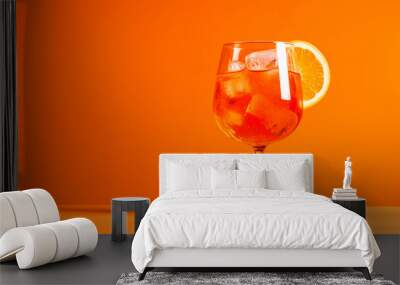 glass of aperol spritz cocktail isolated on orange background Wall mural