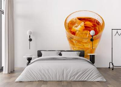 Glass of scotch whiskey and ice over white background. Wall mural