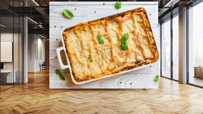 Homemade baked lasagna emiliane made from traditional meat ragù cooked for 4 hours, béchamel sauce, flat pasta. Served in a casserole  and cut into single-serving square portions. Top view.  Wall mural