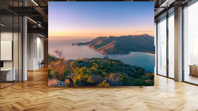 Sunrise landscape of ocean coastline with mountains and beach Wall mural