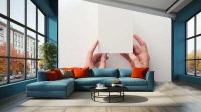 hand holding blank card on white background Wall mural