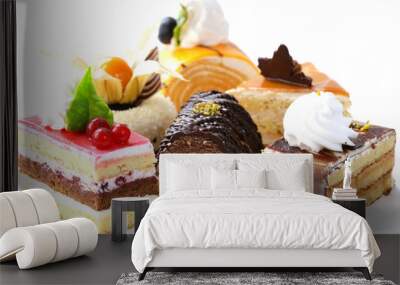 assorted different mini cakes with cream, chocolate and berries Wall mural