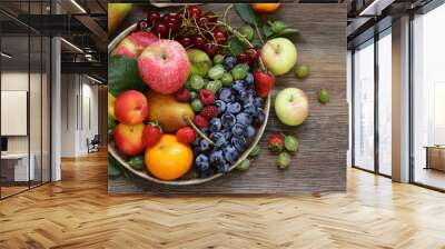 different berries and fruits on a wooden table Wall mural