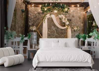 Magnificent decoration of a wedding ceremony with original details and candles. Wall mural