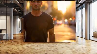 Man in black shirt on a city street at sunset. Wall mural