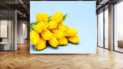 A bouquet of yellow beautiful tulips lies on a blue background. The concept of the holiday is March 8, Women's Day, Valentine's Day, holiday, mother's day, banner. Place for text. Greeting card Wall mural