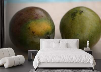 Mango fruit in peel before cooking on table Wall mural