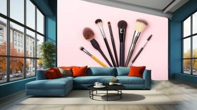 Set of brushes for make up on pink background. Women's secrets. Tools for make up artist with decorative cosmetics Wall mural