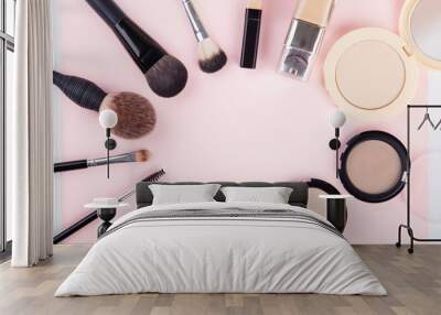 Set of woman's cosmetics on pink background. Women's secrets. Decorative cosmetics: highlighter, concealer, rouge, palette with eye shadows and brushes for face make up, face sculpture . Make up. Wall mural