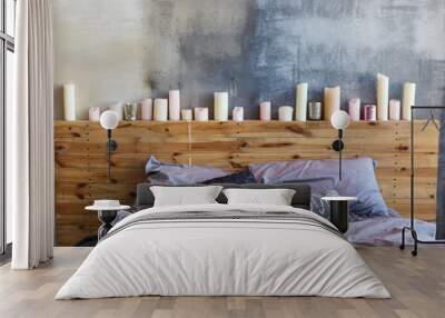 Stylish bedroom in loft style with grey colors and many candles. Bed with dark grey blanket Wall mural