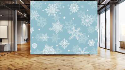 Christmas background of beautiful complex snowflakes, white on light blue. Winter illustration with falling snow. Wall mural