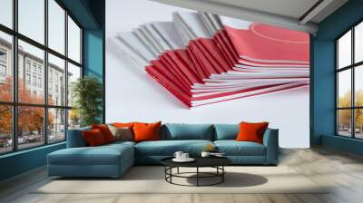 Pile of advertising magazines on a white background. Wall mural