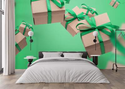 Christmas gift boxes with green ribbon falling or flying in air on green background. shopping Banner Wall mural