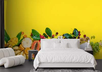 Different exotic tropical fruits berryes on yellow Wall mural