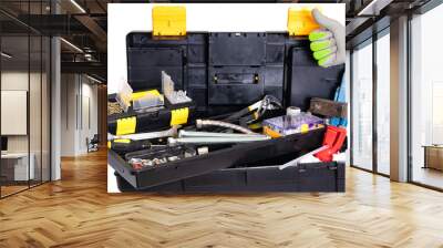 Plumber or carpenter tool box isolated. Black plastic tool kit box with assorted tools and with various nails, screws, fasteners as well as dowels isolated on a white background. Wall mural