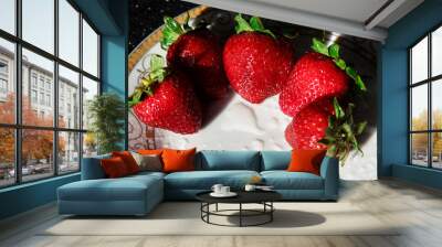 Strawberries on a white plate with a gold pattern. Ripe summer berries in drops of water. Wall mural