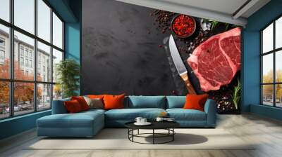 Raw rib eye steak of beef on a wooden Board with a meat cleaver and seasonings Wall mural