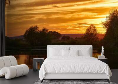 Beautiful sunset on the river bank. Sunset river landscape. River at sunset. Red sunset river Wall mural