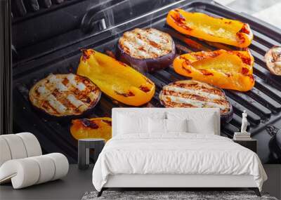 Vegetables: aubergines and yellow pepper on an electric grill. Close-up. Healthy Eating Wall mural