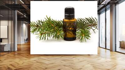 Spruce essential oil in a bottle, with fresh spruce twigs on white background Wall mural