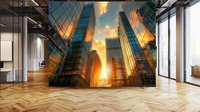 Sunset glows between towering glass skyscrapers, casting reflections and shadows. Wall mural