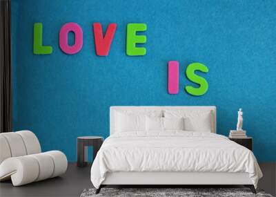 Top view of word  love lettering on blue background, multicolor letters Wall mural