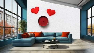 Valentine day concept. Two red hearts and candle on white snow. Wall mural