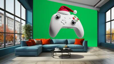 white game controllers gamepad in Santa hats hover on a green background. Christmas for video game lovers	 Wall mural