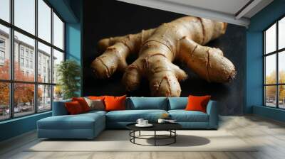 Whole fresh ginger root displayed on a dark background highlighting its unique shape Wall mural