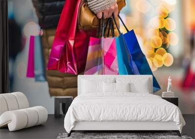 Woman hand  holds lot colorful shopping bags. Boxing Day,  Black Friday in the United States, Boxing Day sales a shopping tradition. Wall mural