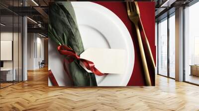 Close up view on setting plate with tag and golden cutlery. Christmas and Valentine table setting top view. Wall mural