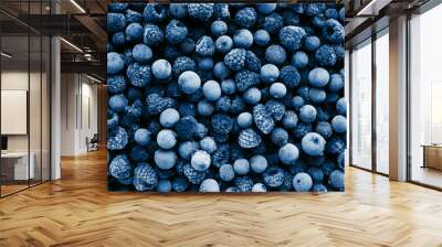 Frozen berries toned in classic blue color, top view. Close up. Wall mural