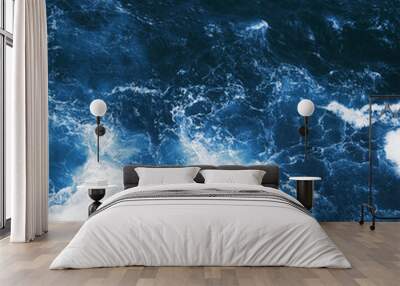 Top view on blue ocean waves and foam. Wall mural