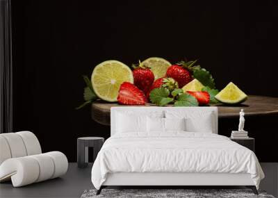 Fresh strawberries,limes and melissa leaves on wooden table on dark background.Close up of fresh fruits. Wall mural