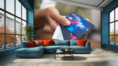 close up woman hand holding heap of credit cards, online payment shopping banking, contactless Credit cards Wall mural