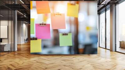 Colorful sticky notes on a glass wall in a bright office. Creative brainstorming and planning session concept for collaboration. Wall mural