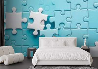 Hand placing final piece into blue puzzle. Concept of completion, solution, and achievement. Wall mural