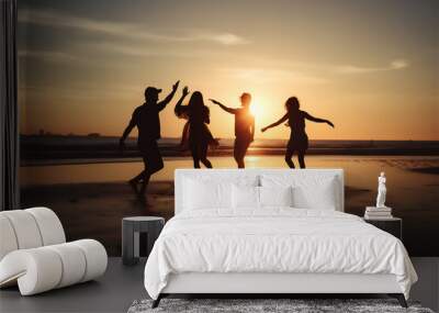 silhouettes of a group of young people running towards sea at sunset, having fun and enjoying beach Wall mural