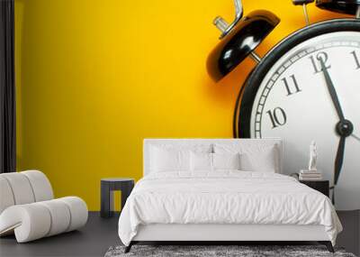 Black retro alarm clock on yellow background top view Flat lay copy space. Minimalistic background, concept of time, deadline, time to work, morning Wall mural