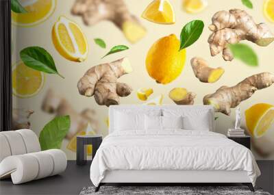 Fresh ginger root, Juicy ripe yellow lemons, green leaves flying on beige background. Creative food concept. Natural organic ginger for health, medicine. Fruit citrus, vitamin C. Lemon slices. Pattern Wall mural