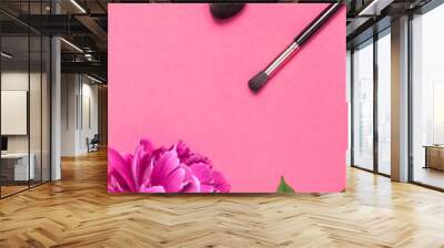 Professional Different makeup brushes with pink spring peonies flowers on pink background flat lay top view copy space. Beauty product, makeup, women's accessory, fashion. Cosmetic makeup Set Wall mural