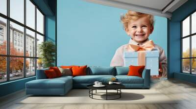 Small boy on a blue background holding a big gift box holiday surprise, compliment, generated by AI Wall mural