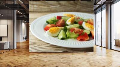 rustic summer salad with fresh cucumbers, tomatoes and eggs on a white plate Wall mural