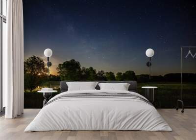 Stars of the Milky Way in the night sky. A view of the starry space background sunset illuminated the horizon. Wall mural