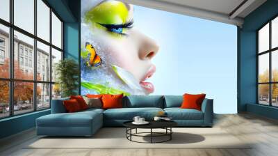 A woman with green eyes and a butterfly on her face. The woman's face is surrounded by water Wall mural