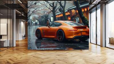 Modern luxury orange car on a wet street Wall mural