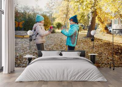 Kids will have fun jumping in autumn Park Wall mural