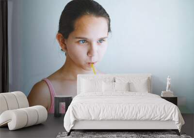 Portrait of happy little girl drinking fruit water. Wall mural