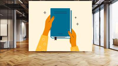 Human hands hold closed book. Student with literature or history textbook. Read books lover. Education, literacy day. Relaxing time to reading. Back to school. Bookstore, library vector illustration Wall mural